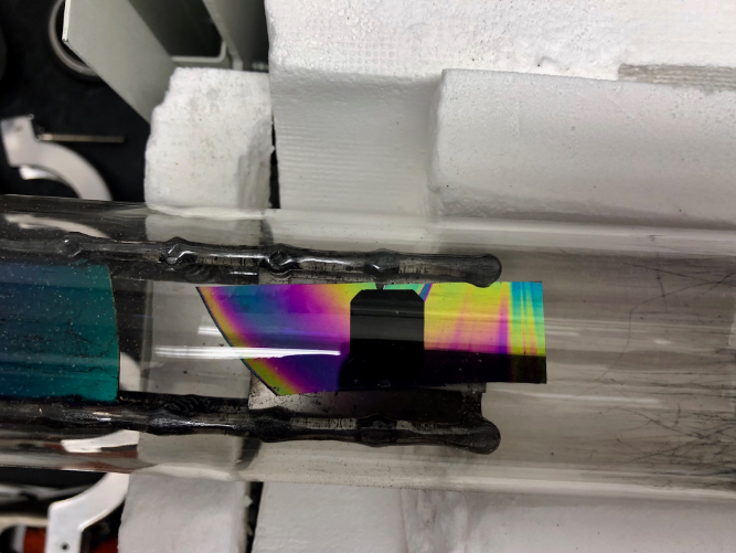 The diamond in the CNT growth chamber in necstlab. The rainbow reflection is from the surface of the shiny Silicon support piece.